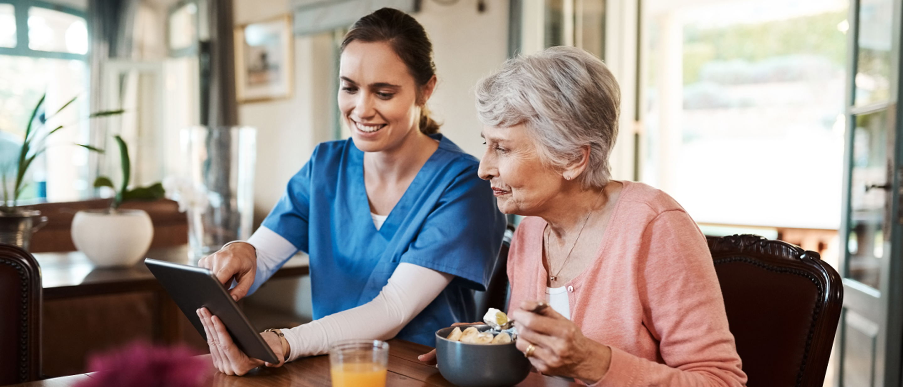 Care provider showing an aged care resident meal options on a tablet