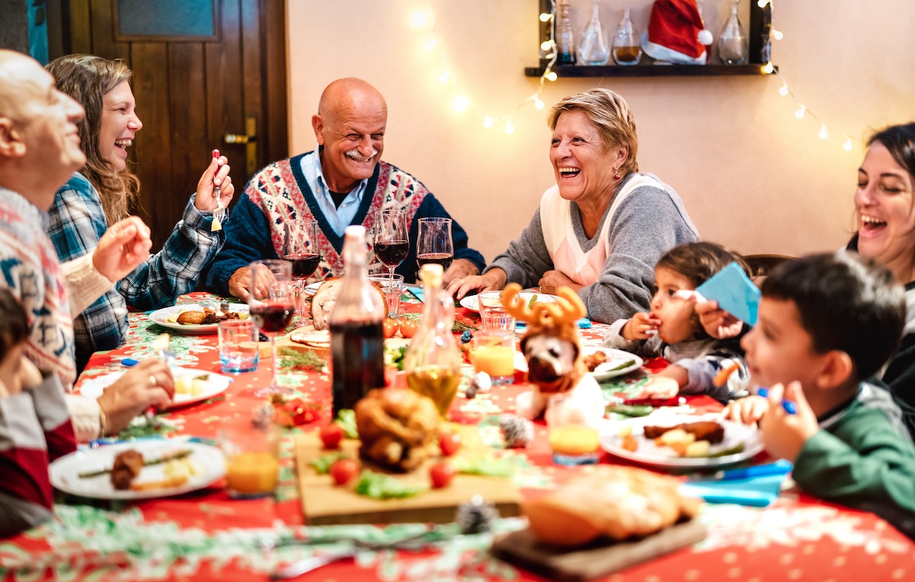 A family gathered around a traditional Christmas dinner table